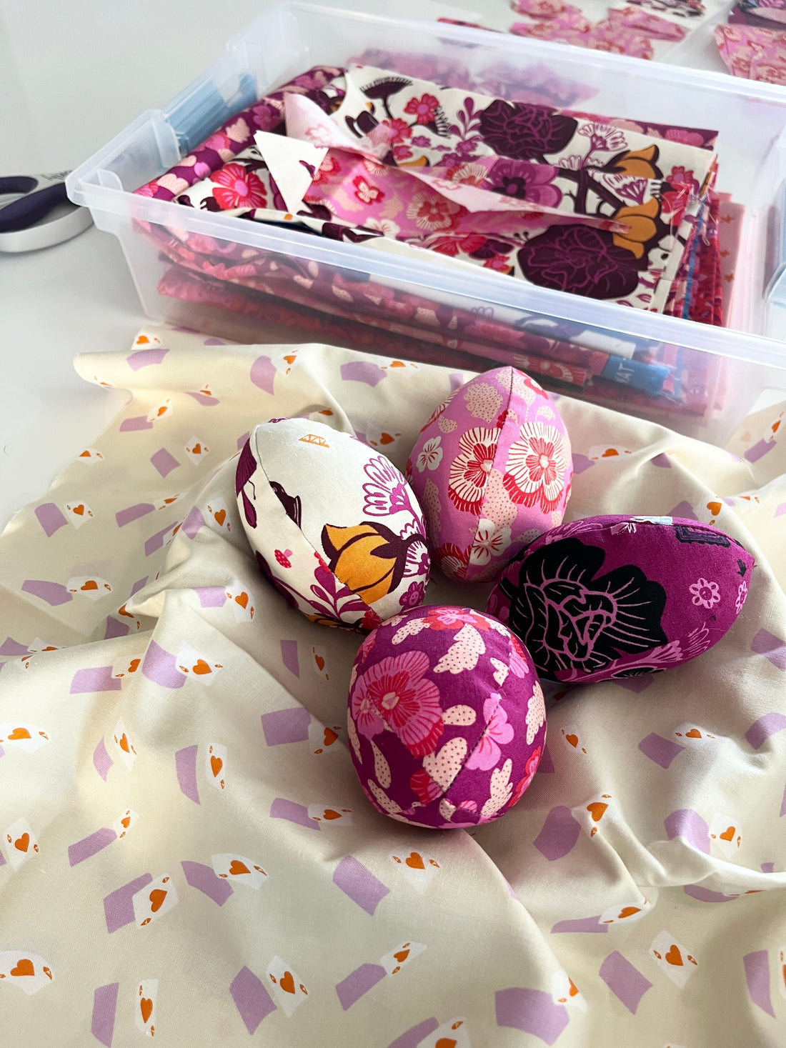 four fabric eggs made from Hello Alice fabric in a little fabric nest.