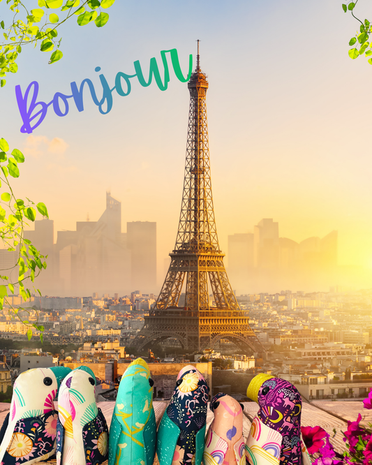 The stuffed animal toucans are looking at the Eiffel Tower.